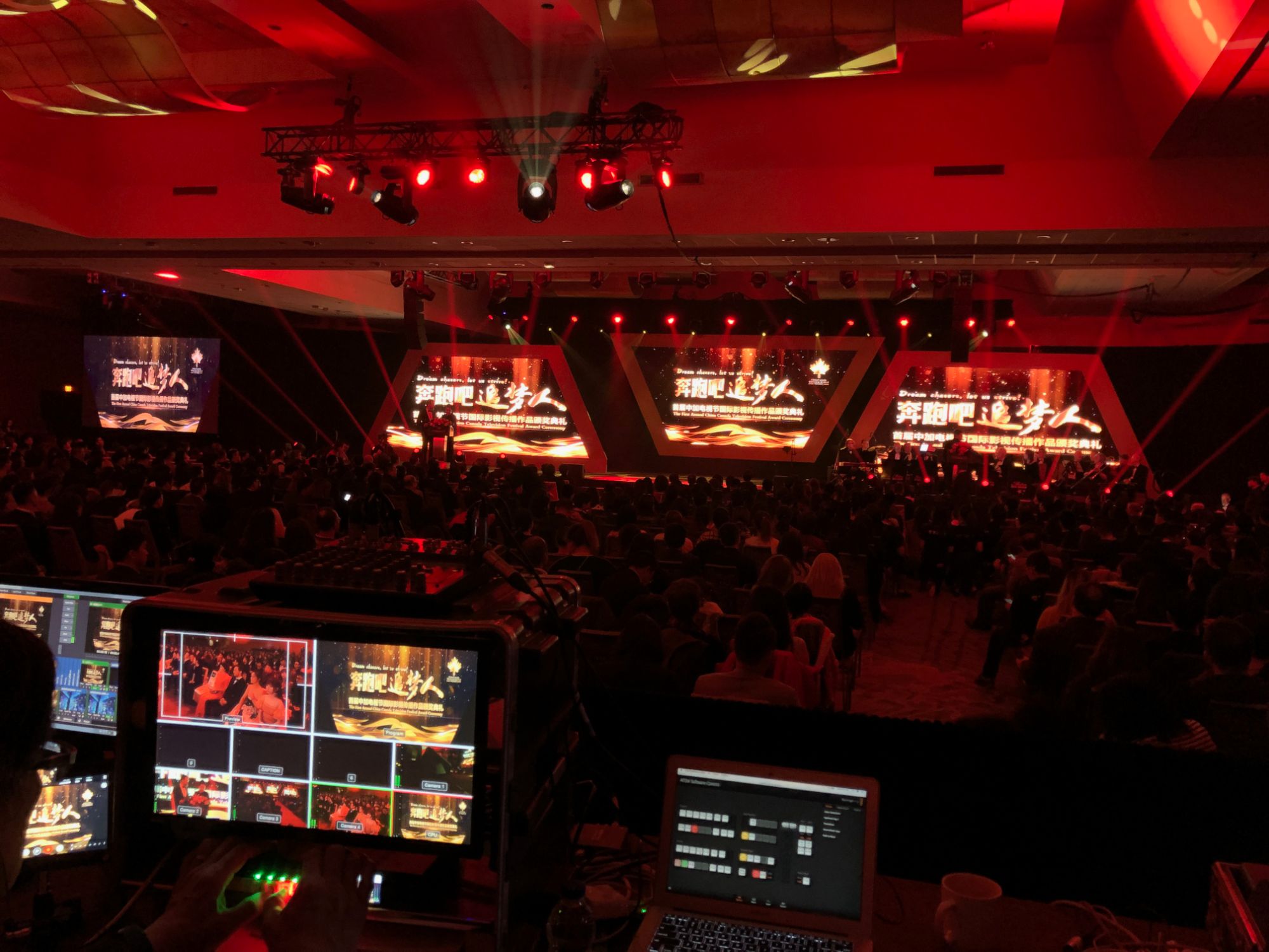 Front-of-house video switcher and multiview monitors during a live award ceremony, three LED screens on stage