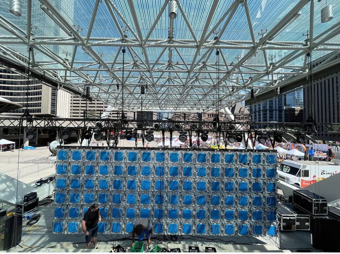 Festival stage with LED wall and lighting truss under a canopy at Nathan Phillips Square, Toronto