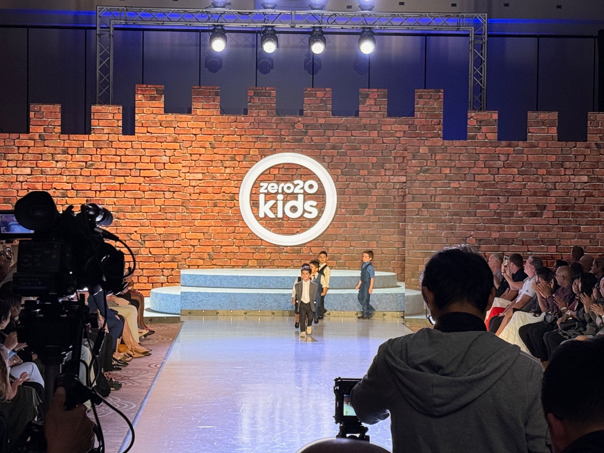 Runway show with content mapped across an LED wall behind the stage
