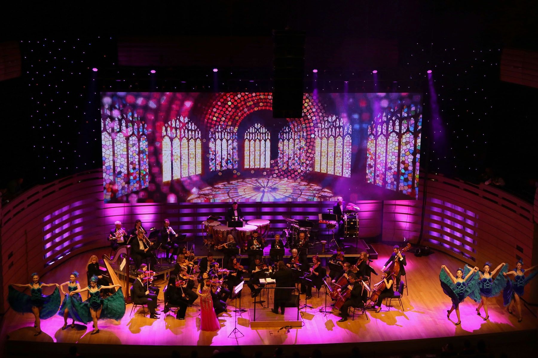 Theatre concert with an orchestra, dancers and a large LED backdrop